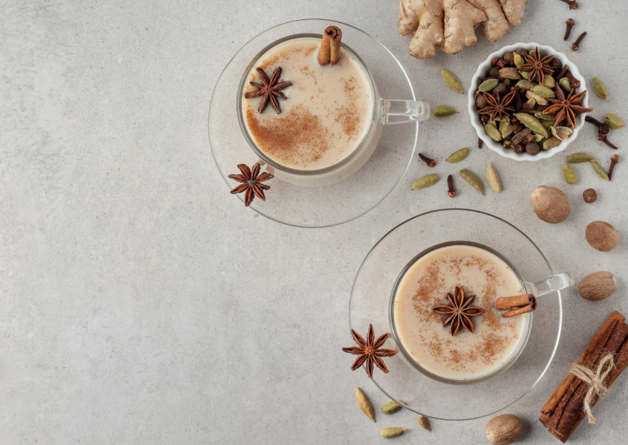 chai ingredients on grey background with cinnamon, star anise, cardamom and pepper - just some of the flavours in our iced chai latte with prebiotics from Good Kynd